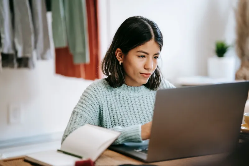 Young professional studying on a laptop at home